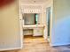 Bathroom boasts a vanity with a wide mirror and lighting in a neutral color palette at 650 Woodridge Drive, Fern Park, FL 32730
