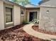 Charming courtyard entrance features a curved walkway and lush landscaping at 650 Woodridge Drive, Fern Park, FL 32730