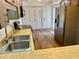 Well-equipped kitchen featuring a stainless steel refrigerator and wood-look floors at 650 Woodridge Drive, Fern Park, FL 32730