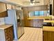 Functional kitchen with stainless steel refrigerator, tile floor and ample cabinet storage at 650 Woodridge Drive, Fern Park, FL 32730