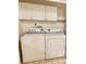 Laundry room featuring washer, dryer, and extra storage at 650 Woodridge Drive, Fern Park, FL 32730