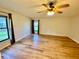 Spacious main bedroom features wood floors, a ceiling fan, and natural light at 650 Woodridge Drive, Fern Park, FL 32730