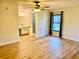 Spacious main bedroom features wood floors, a ceiling fan, and an en suite bathroom at 650 Woodridge Drive, Fern Park, FL 32730