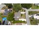 Real estate aerial view featuring a well-maintained lawn and paved driveway at 7 Westchester Dr, Kissimmee, FL 34744