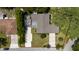 Aerial view of a single-story home with mature trees and manicured landscaping at 7 Westchester Dr, Kissimmee, FL 34744