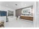 Luxurious bathroom featuring a modern freestanding tub, double vanity, and sleek fixtures at 7 Westchester Dr, Kissimmee, FL 34744