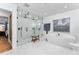 Bright bathroom featuring a modern soaking tub and a walk-in shower with glass surround at 7 Westchester Dr, Kissimmee, FL 34744