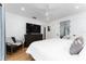 Bedroom featuring a large TV, dresser, and hardwood floors with a ceiling fan at 7 Westchester Dr, Kissimmee, FL 34744