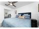 Cozy bedroom features a large bed with decorative pillows and mirrored closet doors at 7 Westchester Dr, Kissimmee, FL 34744