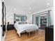 Bright bedroom with hardwood floors, white bedding, ceiling fan, and access to an outdoor deck at 7 Westchester Dr, Kissimmee, FL 34744