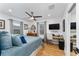 Cozy bedroom with hardwood floors, a ceiling fan, and a built-in desk area with natural light at 7 Westchester Dr, Kissimmee, FL 34744