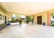 Expansive carport featuring stylish blue planters and a peek into the serene garden at 7 Westchester Dr, Kissimmee, FL 34744