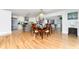 Open dining area with hardwood floors, stylish chandelier, and seamless connection to the modern kitchen at 7 Westchester Dr, Kissimmee, FL 34744