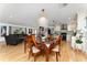 Elegant dining room with chandelier, comfortable seating, and hardwood floors in an open concept home at 7 Westchester Dr, Kissimmee, FL 34744