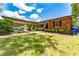 Charming single-story home with a brick facade, well-manicured lawn, and inviting carport at 7 Westchester Dr, Kissimmee, FL 34744