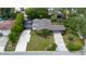 Well-maintained single-story home with a screen enclosed patio and long driveway at 7 Westchester Dr, Kissimmee, FL 34744