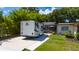 Exterior shot of a home with a large RV parked next to a screened in porch at 7 Westchester Dr, Kissimmee, FL 34744