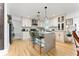 Well-lit kitchen features an island with granite countertops, modern appliances, and white cabinetry at 7 Westchester Dr, Kissimmee, FL 34744