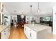 Open kitchen with granite counters, stainless steel appliances and seamless flow to the dining room at 7 Westchester Dr, Kissimmee, FL 34744