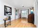 Bright living room with hardwood floors, stylish decor, and natural light from two windows at 7 Westchester Dr, Kissimmee, FL 34744