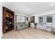 Bright living room features hardwood floors, cozy seating, and a built-in bar area at 7 Westchester Dr, Kissimmee, FL 34744