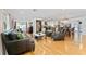 Spacious living room with hardwood floors, leather sofas, and an open floor plan to kitchen and dining at 7 Westchester Dr, Kissimmee, FL 34744