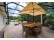 Spacious screened-in porch with dining and lounge areas, perfect for outdoor living at 7 Westchester Dr, Kissimmee, FL 34744