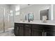 Elegant bathroom featuring a double sink vanity, walk-in shower, and modern fixtures at 7876 Marlow Pl, Kissimmee, FL 34746