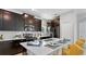 Stylish kitchen featuring dark cabinets, a quartz countertop island and stainless steel appliances at 7876 Marlow Pl, Kissimmee, FL 34746