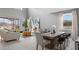Open-concept living and dining area with contemporary furnishings and abundant natural light at 7876 Marlow Pl, Kissimmee, FL 34746