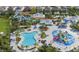 Aerial view of a large community pool area with water slides, splash pads, and seating at 7876 Marlow Pl, Kissimmee, FL 34746