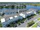 Aerial view of modern townhomes near a serene lake, showcasing the community's layout and landscaping at 8460 Sperry St, Orlando, FL 32827