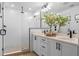 Modern bathroom with double sinks, quartz countertops, black fixtures, and a glass shower with subway tile at 8460 Sperry St, Orlando, FL 32827