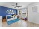 Well-lit bedroom with custom blue wall, hardwood floors, and fan at 8460 Sperry St, Orlando, FL 32827