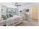 Serene bedroom featuring soft colors, a plush bed, natural light, and a doorway to the en suite bathroom at 8460 Sperry St, Orlando, FL 32827