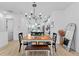 Stylish dining area featuring a modern chandelier, table with bench seating, and seamless flow to the kitchen at 8460 Sperry St, Orlando, FL 32827