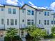 Charming townhome featuring a stylish exterior, lush greenery, and a welcoming entrance with a lovely wreath at 8460 Sperry St, Orlando, FL 32827