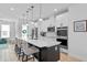 Modern kitchen featuring a large center island with pendant lighting, sleek stainless steel appliances, and white cabinets at 8460 Sperry St, Orlando, FL 32827