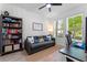 Relaxing space with a gray sofa, bookshelf, and a window offering natural light for work or leisure at 8460 Sperry St, Orlando, FL 32827
