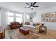 Cozy living room with a ceiling fan, large windows, comfortable sofas, and a stylish rug for a warm atmosphere at 8460 Sperry St, Orlando, FL 32827