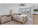 Bright main bedroom with a ceiling fan, soft carpet, ample light, and stylish, cottage-style furniture at 8460 Sperry St, Orlando, FL 32827