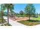 Community playground with modern equipment and a sidewalk leading up to the park at 8460 Sperry St, Orlando, FL 32827