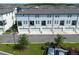 Modern light blue townhomes featuring balconies and attached garages in a well-maintained community setting at 8460 Sperry St, Orlando, FL 32827