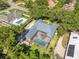 Aerial view of home with screened-in pool, lush landscaping, and elegant patio furniture at 8812 S Bay Dr, Orlando, FL 32819