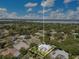 Expansive aerial view of a property with a pool surrounded by lush landscaping and neighborhood, showcasing its serene setting at 8812 S Bay Dr, Orlando, FL 32819