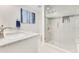 Bright bathroom with a glass shower enclosure and white vanity and marble countertops at 8812 S Bay Dr, Orlando, FL 32819