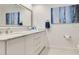 Bright bathroom with white vanity and marble countertops with painting on the wall at 8812 S Bay Dr, Orlando, FL 32819