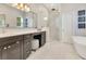 Main bathroom featuring a large vanity area with a make up area, walk in shower, and soaking tub at 8812 S Bay Dr, Orlando, FL 32819