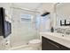 Bathroom featuring a glass shower enclosure, with a dark vanity and modern countertop at 8812 S Bay Dr, Orlando, FL 32819