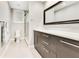 Bathroom featuring a glass enclosed shower, grey vanity and dark framed mirror with white countertop at 8812 S Bay Dr, Orlando, FL 32819